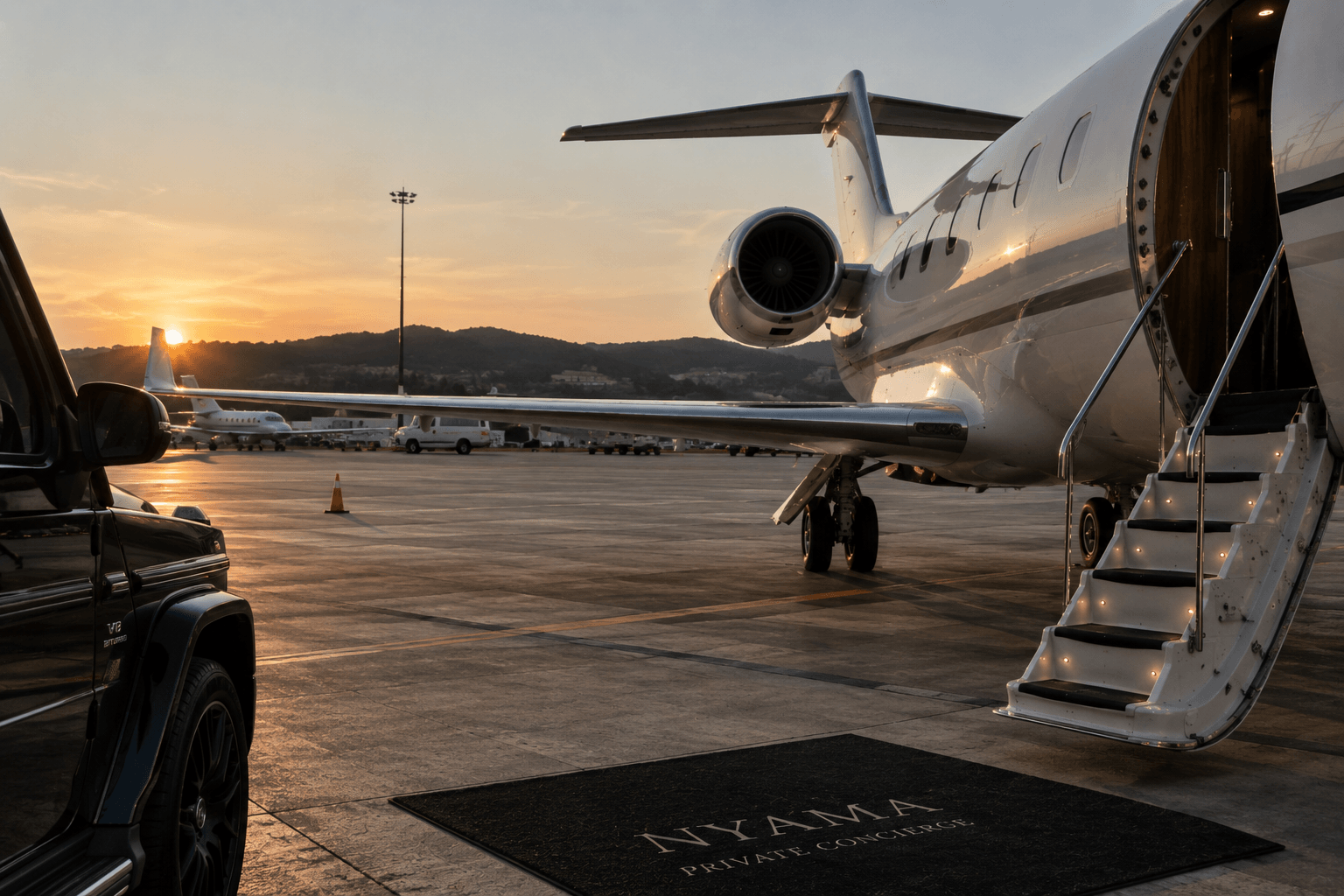 A private jet with its stairs lowered on the apron at sunset