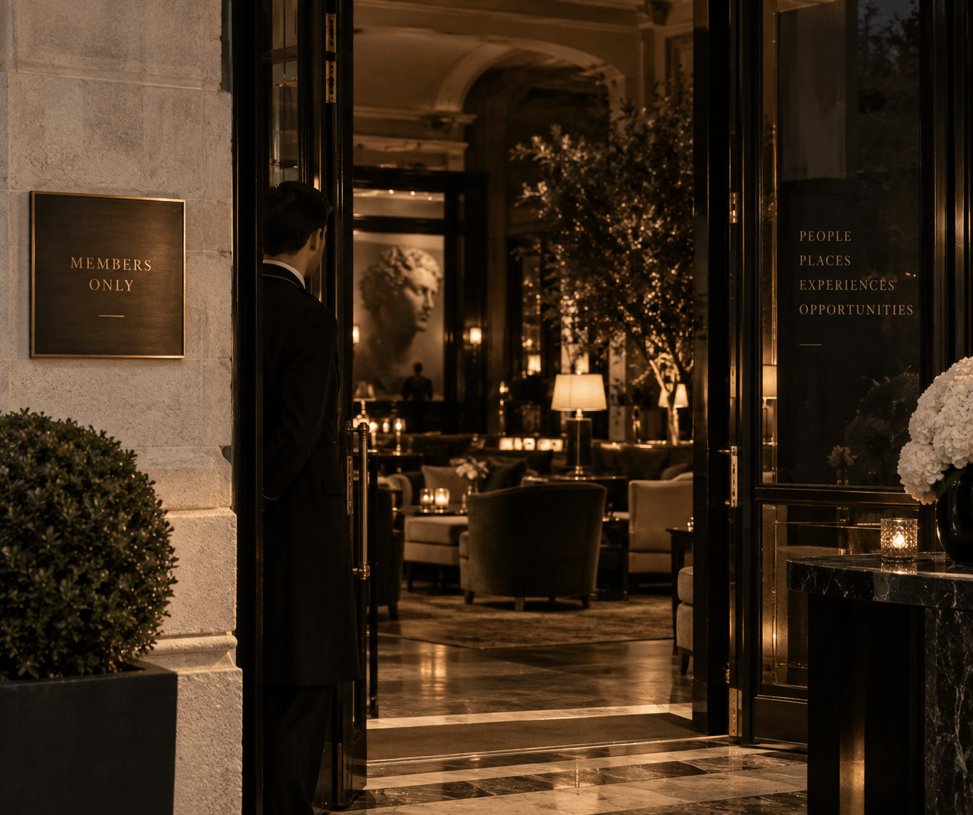 A doorman at the open door of a private members club in the evening